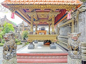 A traditional Balinese temple with ornate carvings and a central altar.