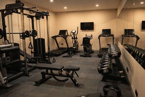 A gym with various exercise equipment including treadmills, elliptical machines, and free weights. - Ramada Encore by Wyndham Istanbul Arnavutkoy (Istanbul)