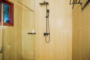 A shower with a handheld showerhead and a wall-mounted faucet. - Shose Farmhouse & Chalets (Moshi)