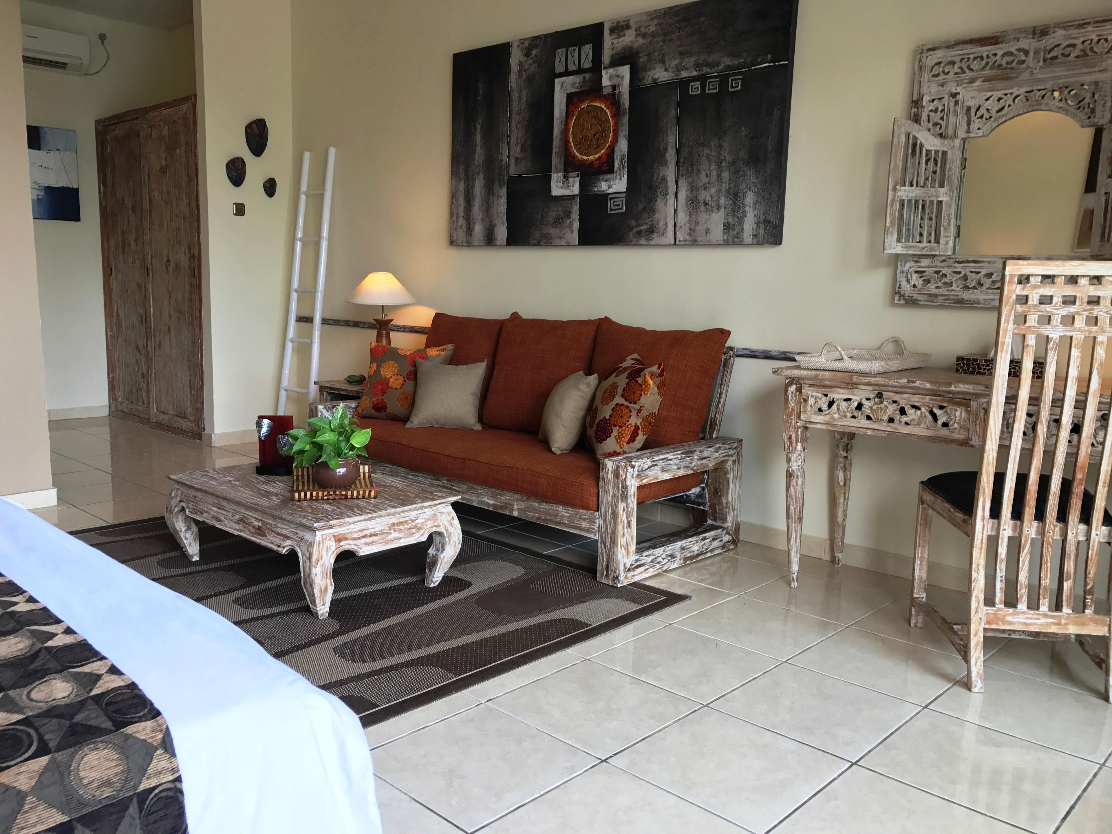 A living room with a sofa, coffee table, and decorative items.