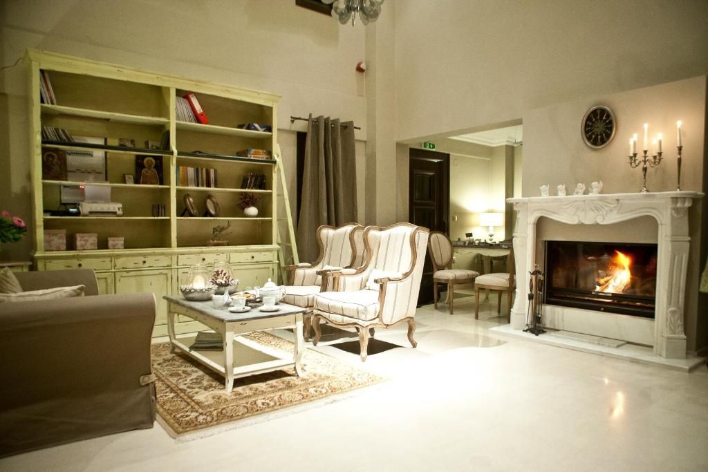 A living room with a fireplace, a bookshelf, and a sofa.