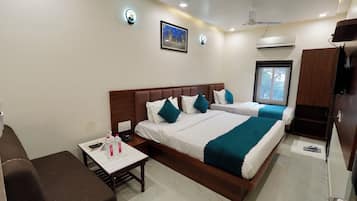 A hotel room with a bed, bedside table, and a window.