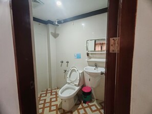 A bathroom with a toilet, sink, and shower. - Jace's Travellers Inn By Zuzu (El Nido)