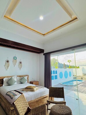 A bedroom with a bed, bedside tables, a chair, a view of a swimming pool, and a balcony. - Volcano Side Kintamani Bali By Zuzu (Kintamani)