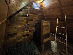 A wooden interior with a shower, a ladder, and a small trash bin. - Volcano Side Kintamani Bali By Zuzu (Kintamani)
