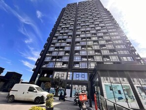 A high-rise building with multiple floors, large windows, and a modern architectural design. - G Tower Residence - Near Mimar Sinan Metro Station (Istanbul)