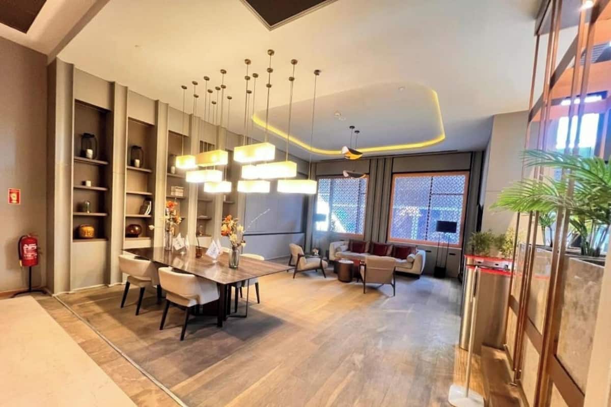 Ein modernes Interieur mit Essbereich, Sofas und einem großen Fenster.