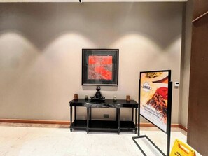 A room with a black console table, a framed artwork, and a poster on the wall. - G Tower Residence - Near Mimar Sinan Metro Station (Istanbul)