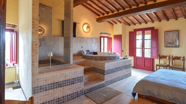 A bathroom with a stone-tiled shower, a bathtub, and a toilet. - Lovely home in Casciana Terme (Casciana Terme)