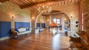 A spacious living area with a grand piano, wooden floors, and a vaulted stone ceiling. - Lovely home in Casciana Terme (Casciana Terme)