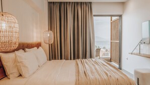 A bedroom with a large bed, a view of the sea, and a balcony. - Sagredo Boutique Hotel And Spa (Kos)
