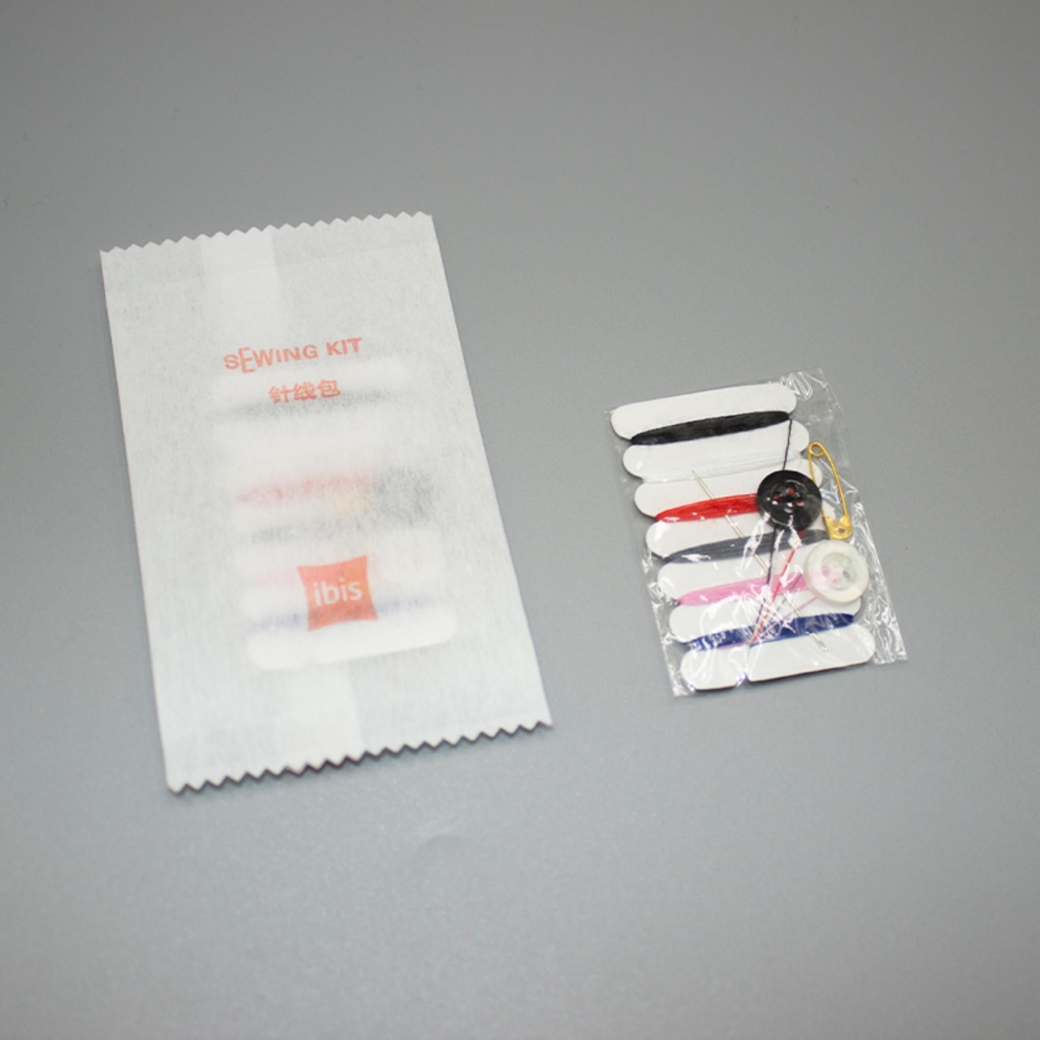 A sewing kit with thread spools and a label.