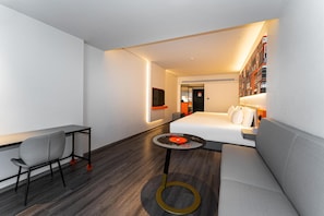 A modern hotel room with a bed, a desk, a chair, a small table, and a bookshelf. - Ibis Xian Bell Tower Huimin Street (Xi'an)