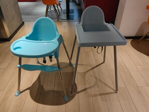 Two high chairs with metal legs and a table in a room with wooden flooring. - Ibis Hotel (Shanghai)
