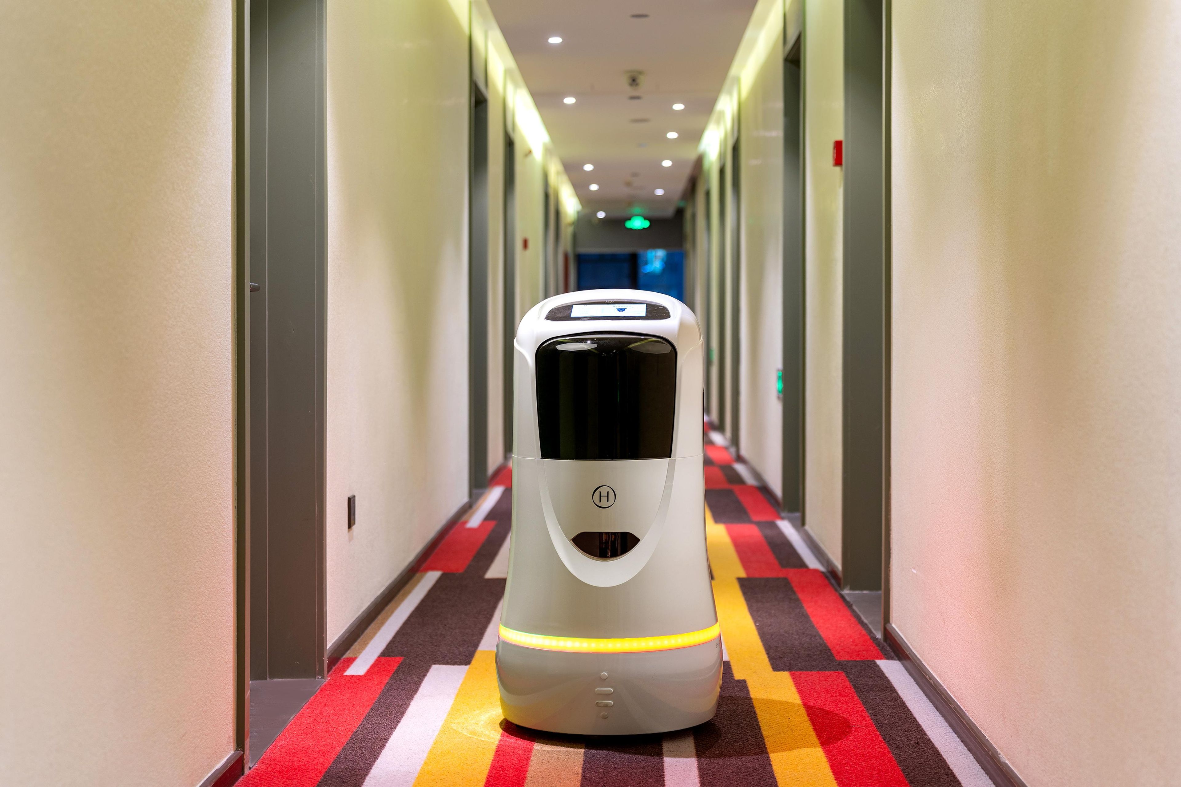 A hallway with a self-service luggage cart.