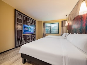 A hotel room with a large bed, a flat-screen TV mounted on a black wall, a window with curtains, and a city view. - Ibis Chengdu Kuanzhai Alley Center Hotel (Chengdu)