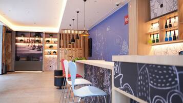 A modern interior with a reception desk, seating area, and decorative wall art.