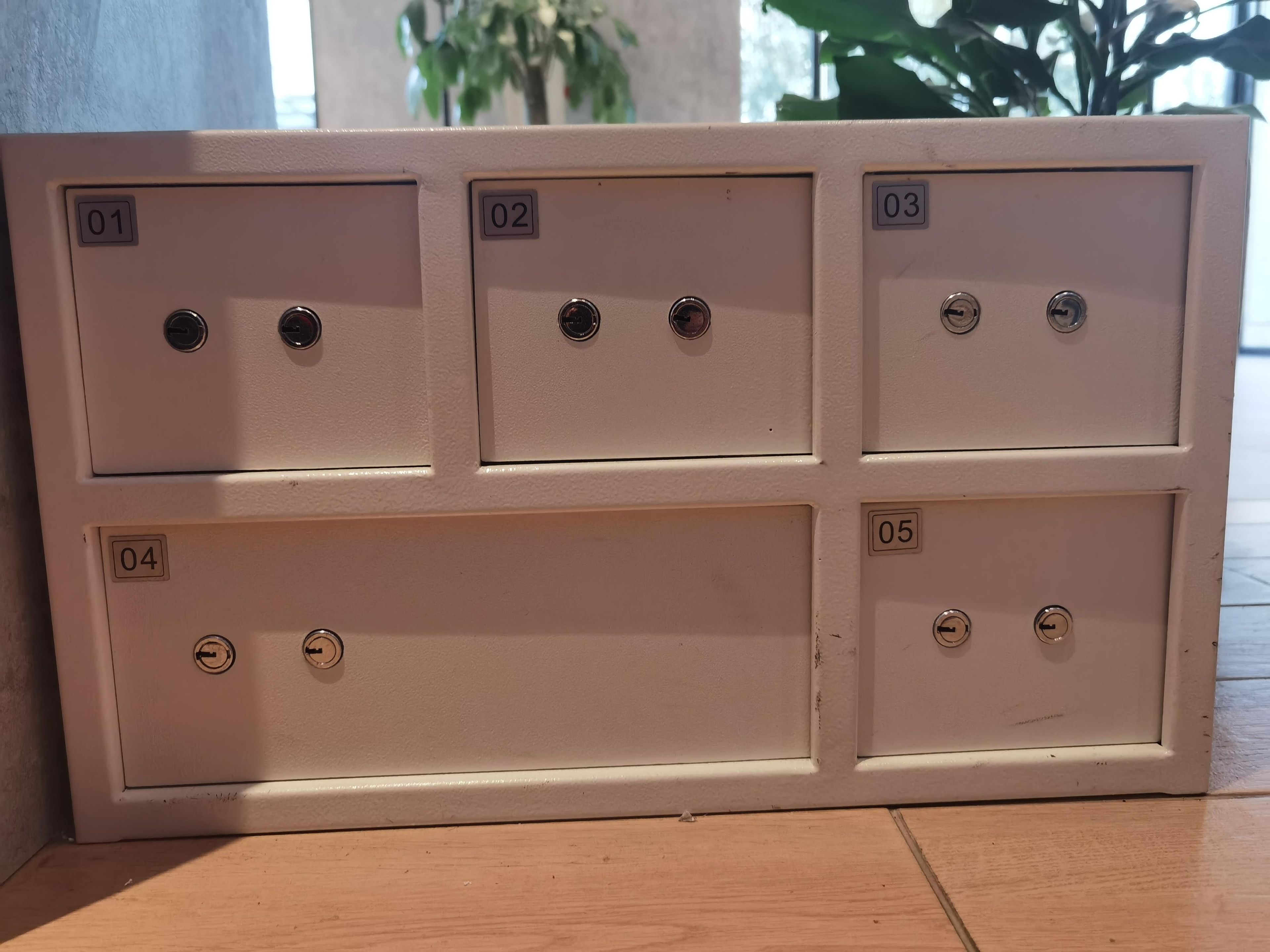 A wall-mounted electrical panel with six numbered compartments, each with a switch or socket.