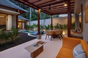 A covered outdoor area with a pool, seating, and a dining setup. - Asvara Luxury Resort Ubud By Ini Vie hospitality (Payangan)