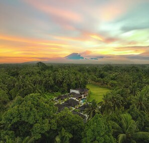 A resort with multiple buildings, a swimming pool, and lush tropical vegetation. - Asvara Luxury Resort Ubud By Ini Vie hospitality (Payangan)