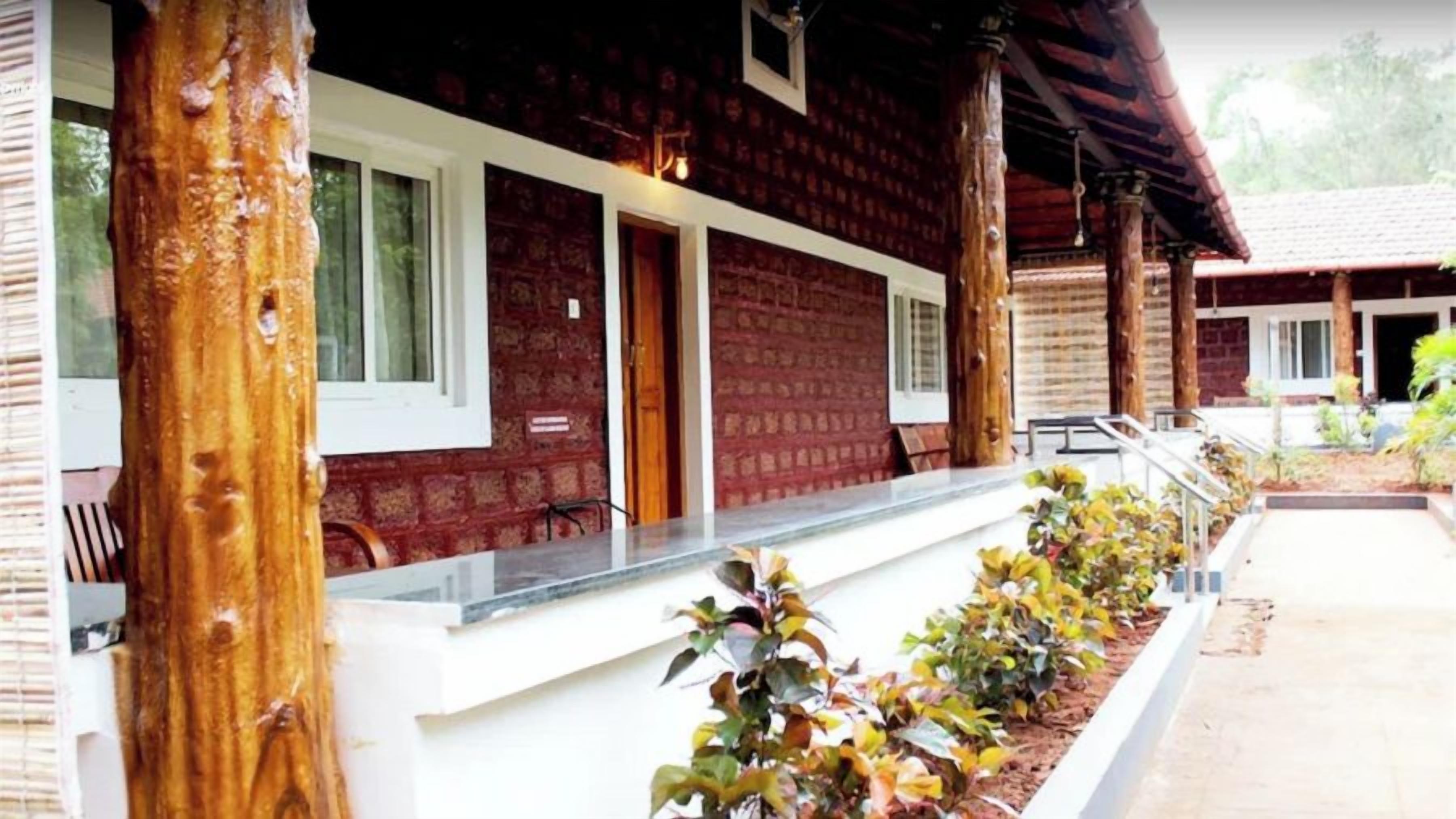 A building with a brick exterior, wooden pillars, and a white counter.