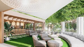 A modern outdoor lounge area with seating arrangements, a bar, and a pergola structure. - Maspalomas Villas By Dunas (San Bartolomé de Tirajana)