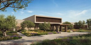 A modern building with a flat roof, stone facade, and a covered outdoor area with a paved walkway. - Ikos Kissamos (Kissamos)