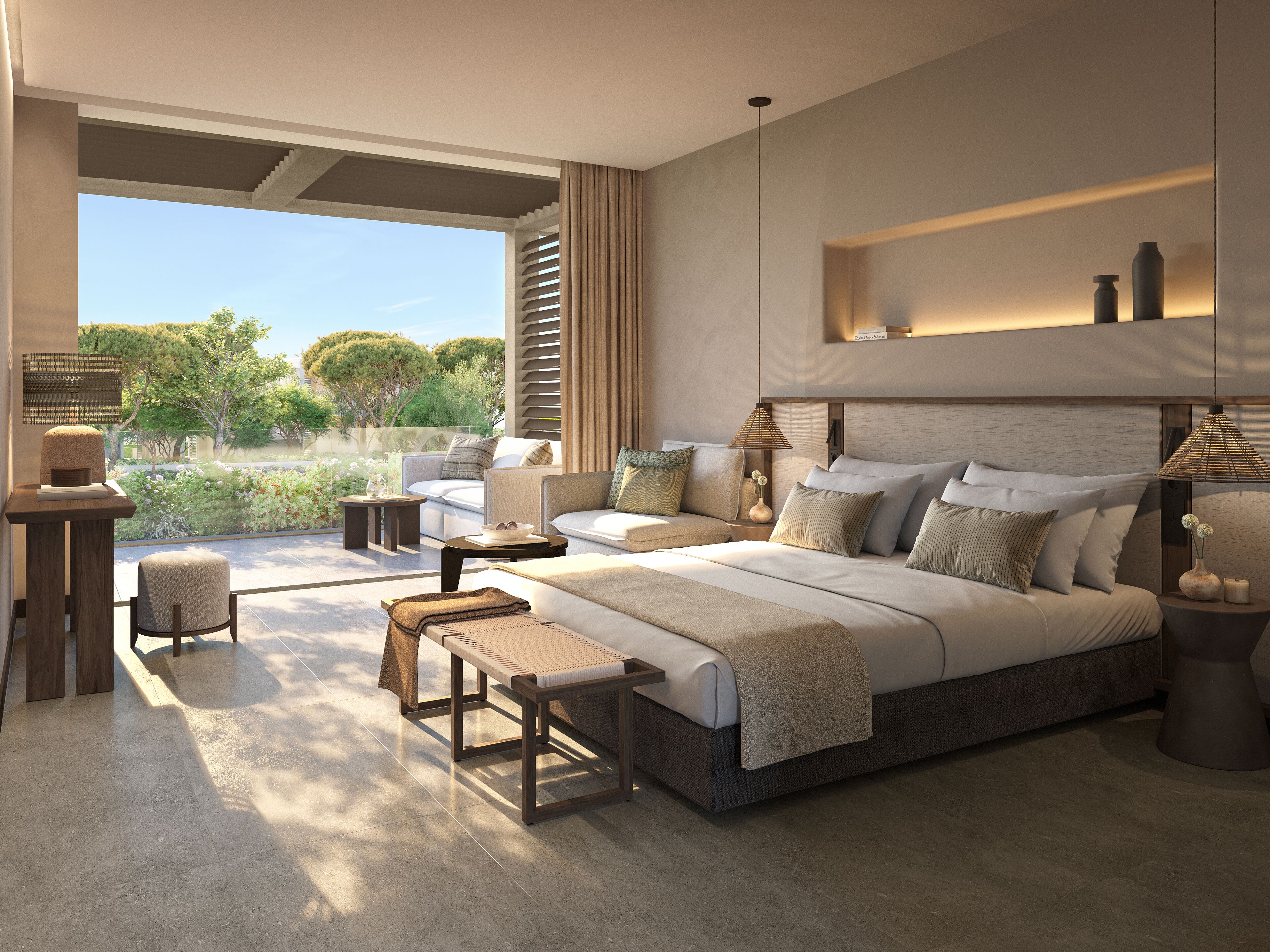 A modern bedroom with a large bed, a seating area, and a view of greenery.