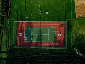 An aerial view of a sports court with surrounding green areas and pathways. - Maiyan Resort (Nanyuki)
