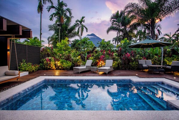 A swimming pool with lounge chairs and a view of a mountain. - Arenal Manoa Resort And Hot Springs (La Fortuna)
