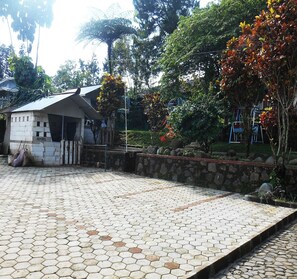 A hexagonal tiled area with a small building labeled 'Angel' and a stone wall.