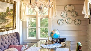 A room with a large window, a globe on a table, and a collection of plates on the wall. - Beautiful home in Bagn with WiFi (Bagn)