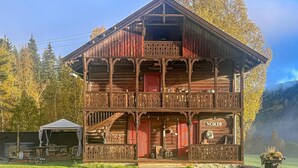 A wooden building with a balcony, a sign reading 'NORDI', and a view of a lake and forest in the background. - Beautiful home in Bagn with WiFi (Bagn)