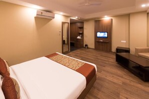 A hotel room with a bed, a TV, a sofa, and a desk. - Le Roi Digha@ Digha Railway Station (Kanthi)