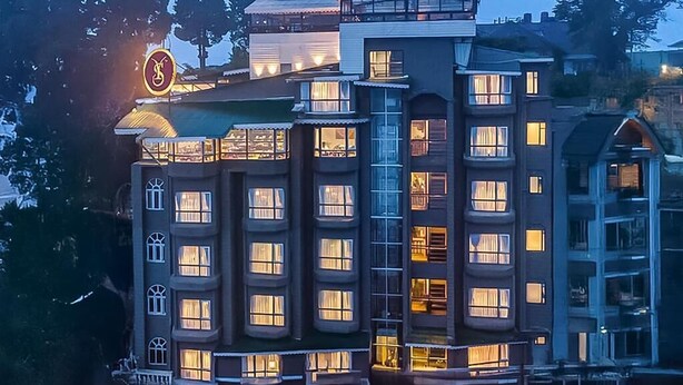 A multi-story hotel with a prominent sign, balconies, and a modern architectural design. - Sumitel Vista 800m From Mall Road (Darjeeling)