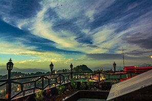 A bridge with railings, a cityscape in the background, and a partly cloudy sky. - Sumitel Vista 800m From Mall Road (Darjeeling)