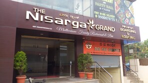 A building with a sign for 'The Nisarga Grand' and 'Bee Gee Complete'. - The Nisarga Grand Bangalore India (Bengaluru)
