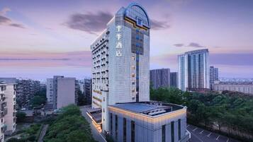 A high-rise hotel with a modern design, featuring a prominent curved top and multiple floors.