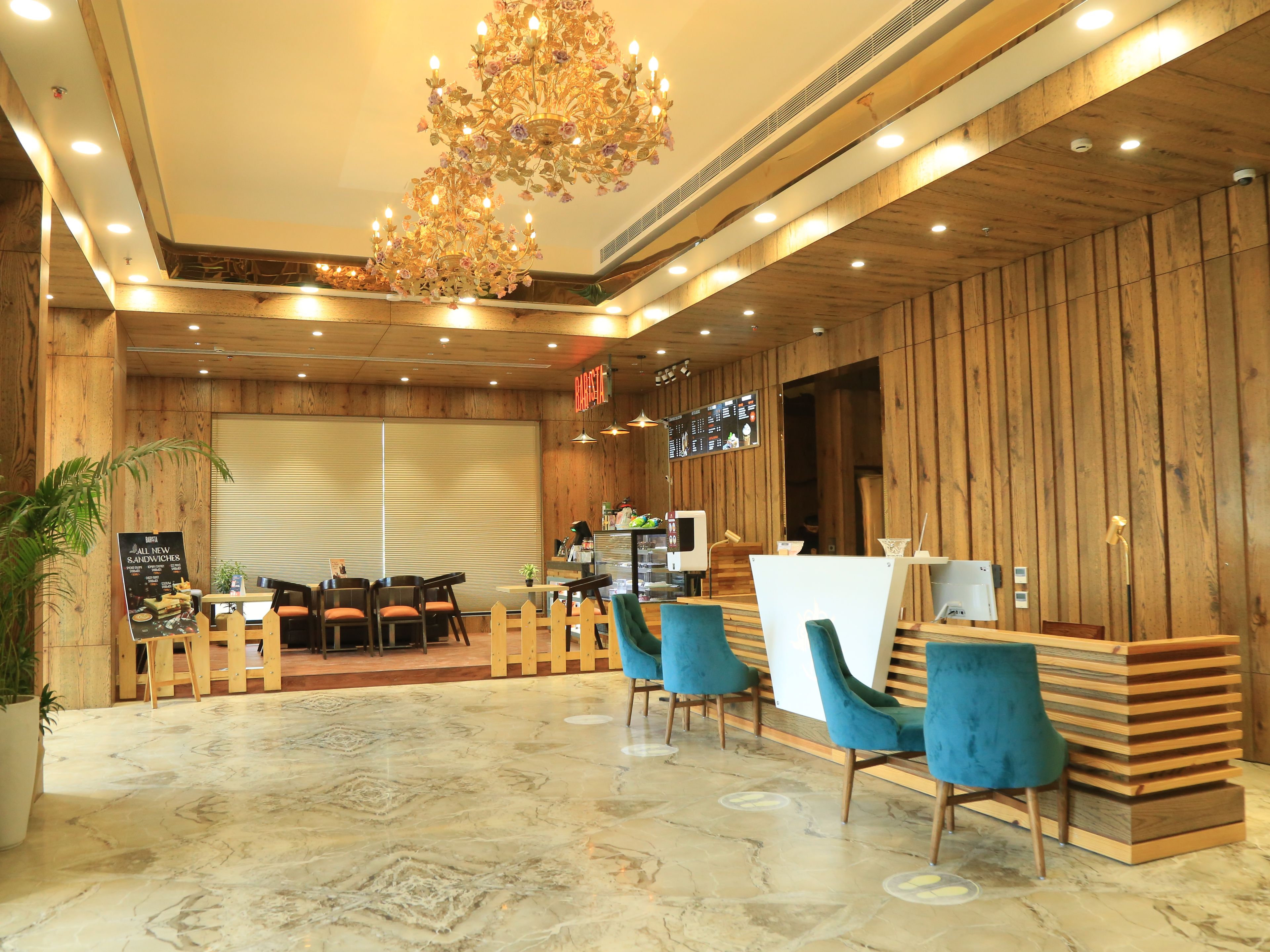 A restaurant interior with wooden walls, a marble floor, and blue chairs.