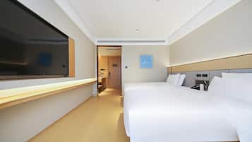 A hotel room with a large bed, a bedside table, a window, and a door leading to a hallway.