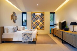 A modern bedroom with a bed, a TV, a cabinet, and a decorative wall panel. - Vinila Villas (Nusa Dua)