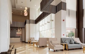 A spacious lobby with a modern staircase, seating areas, and large windows. - Seiba Hotel (Riyadh)