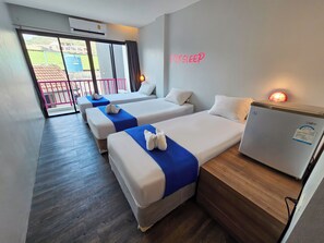 A hotel room with three beds, a minibar, and a sliding glass door to the outside. - Slumber Party Surf Kata (Karon)