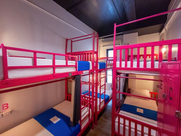 A bunk bed room with a window, a door, and a wall-mounted air conditioning unit. - Slumber Party Surf Kata (Karon)