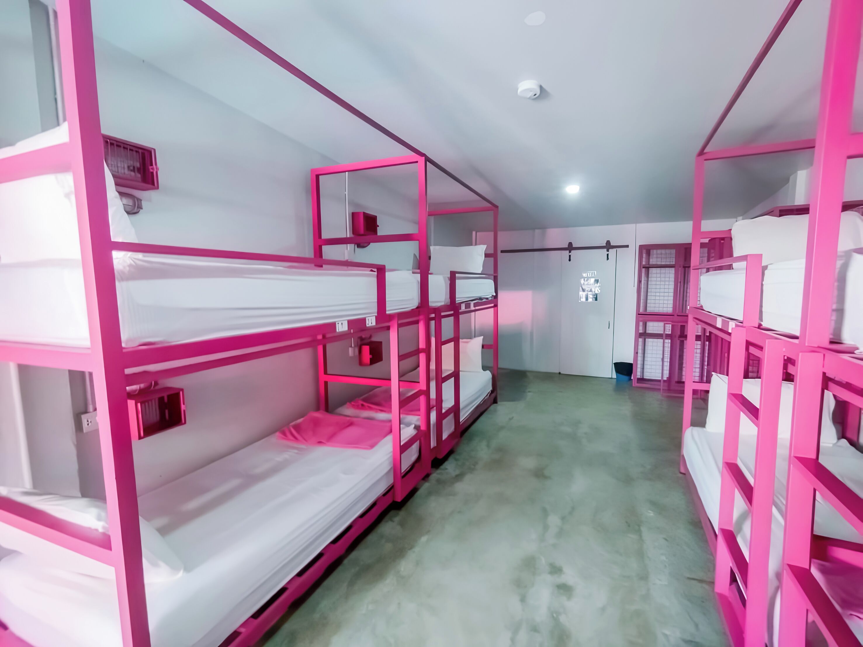 A room with bunk beds, a closet, and a door with a poster.