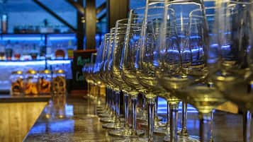 A bar with a row of empty wine glasses.