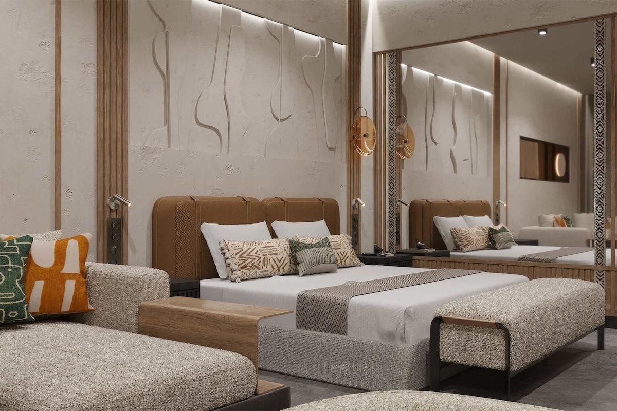 A modern bedroom with a large bed, a sofa, and a bench.