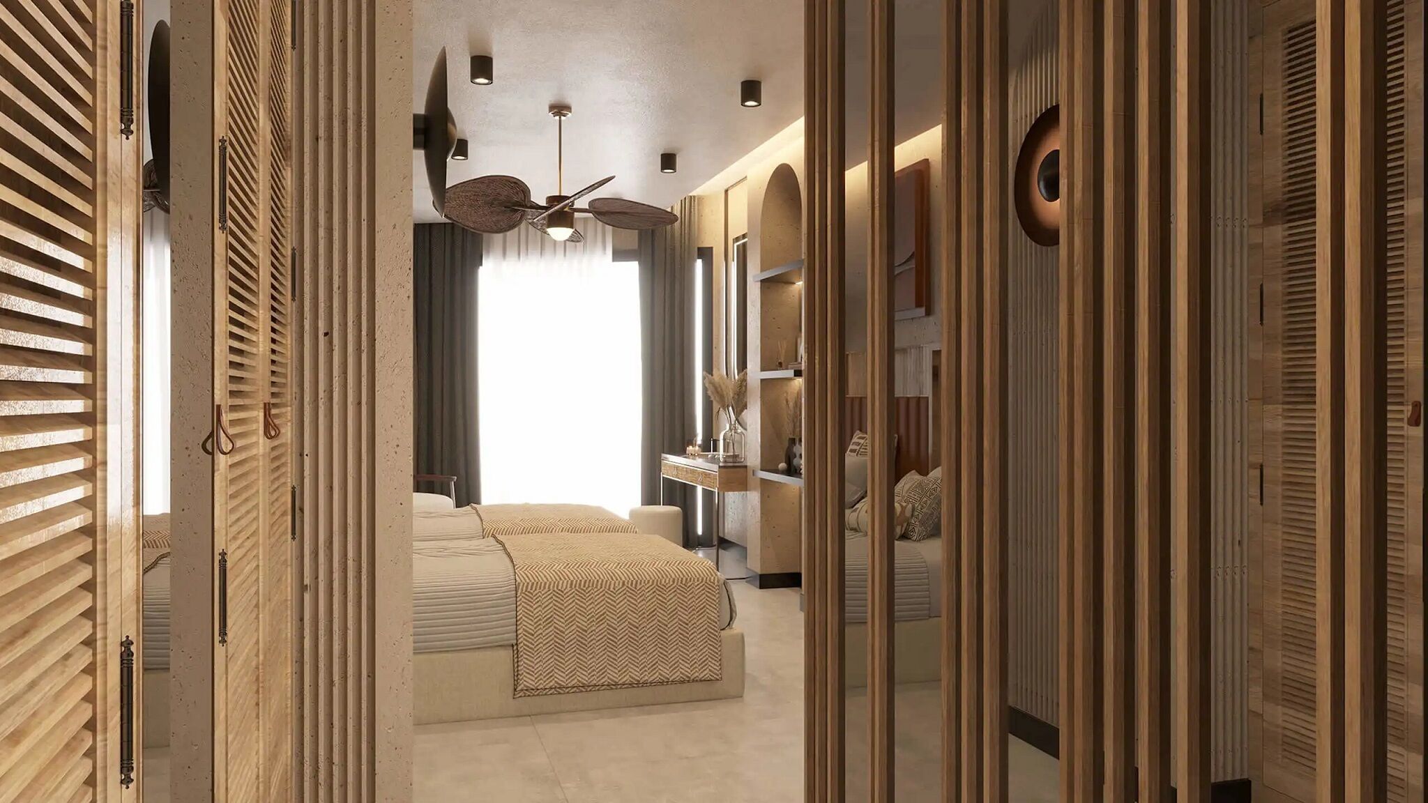 A walk-in closet with wooden slat doors, a bed with a patterned bedspread, a ceiling fan, and a mirror.
