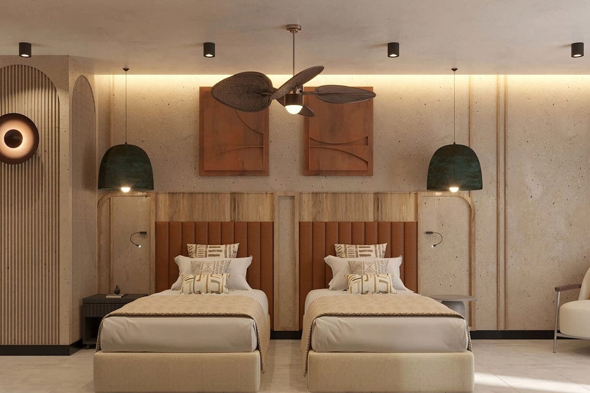A modern bedroom with two beds, a ceiling fan, and a unique circular light fixture.