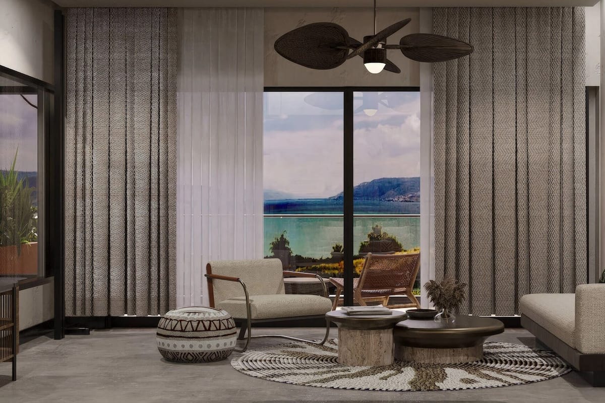 A modern living room with a large window, a ceiling fan, and a view of a body of water.
